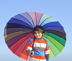 カラフルな傘をさす男の子